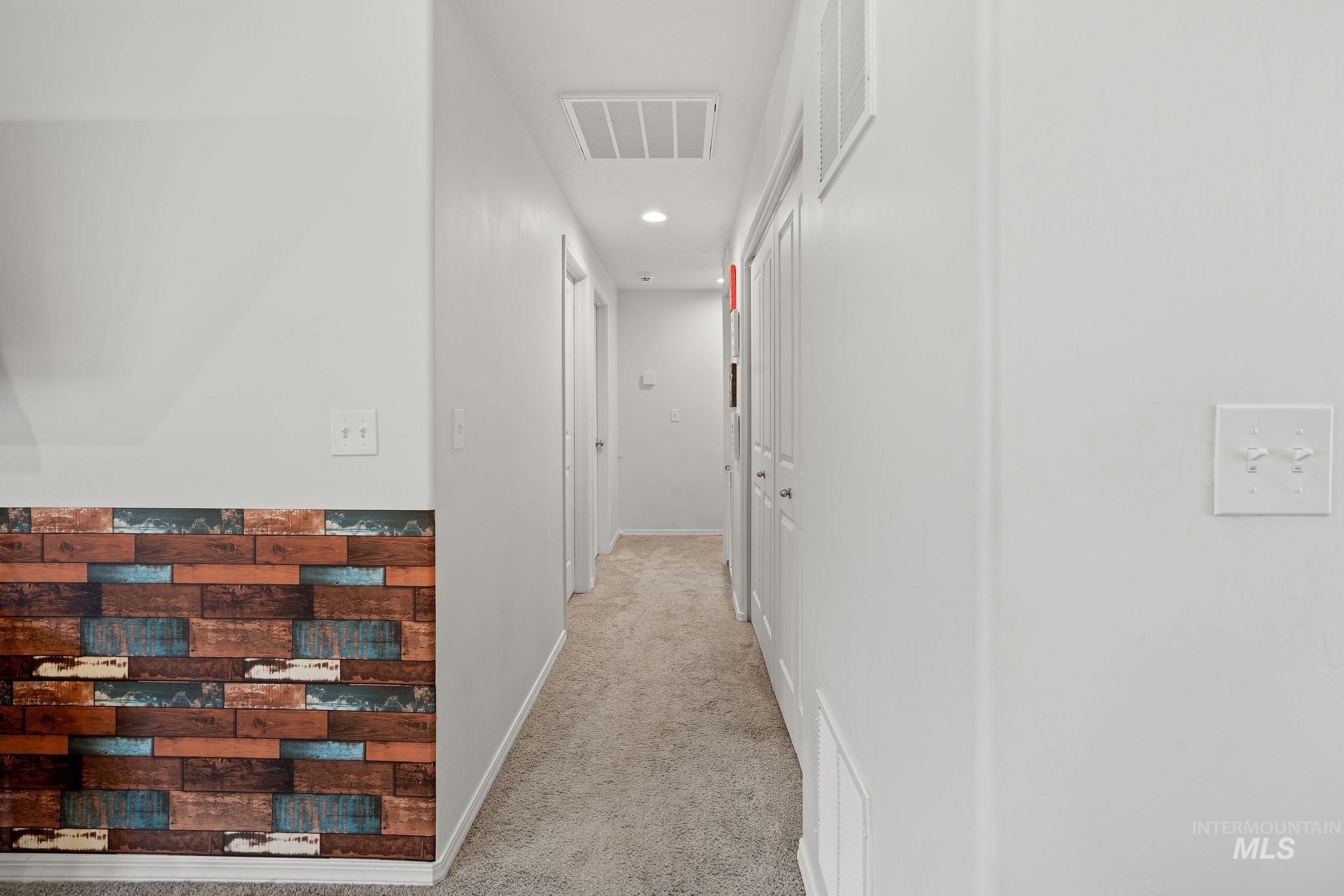 Corridor featuring light colored carpet and recessed lighting