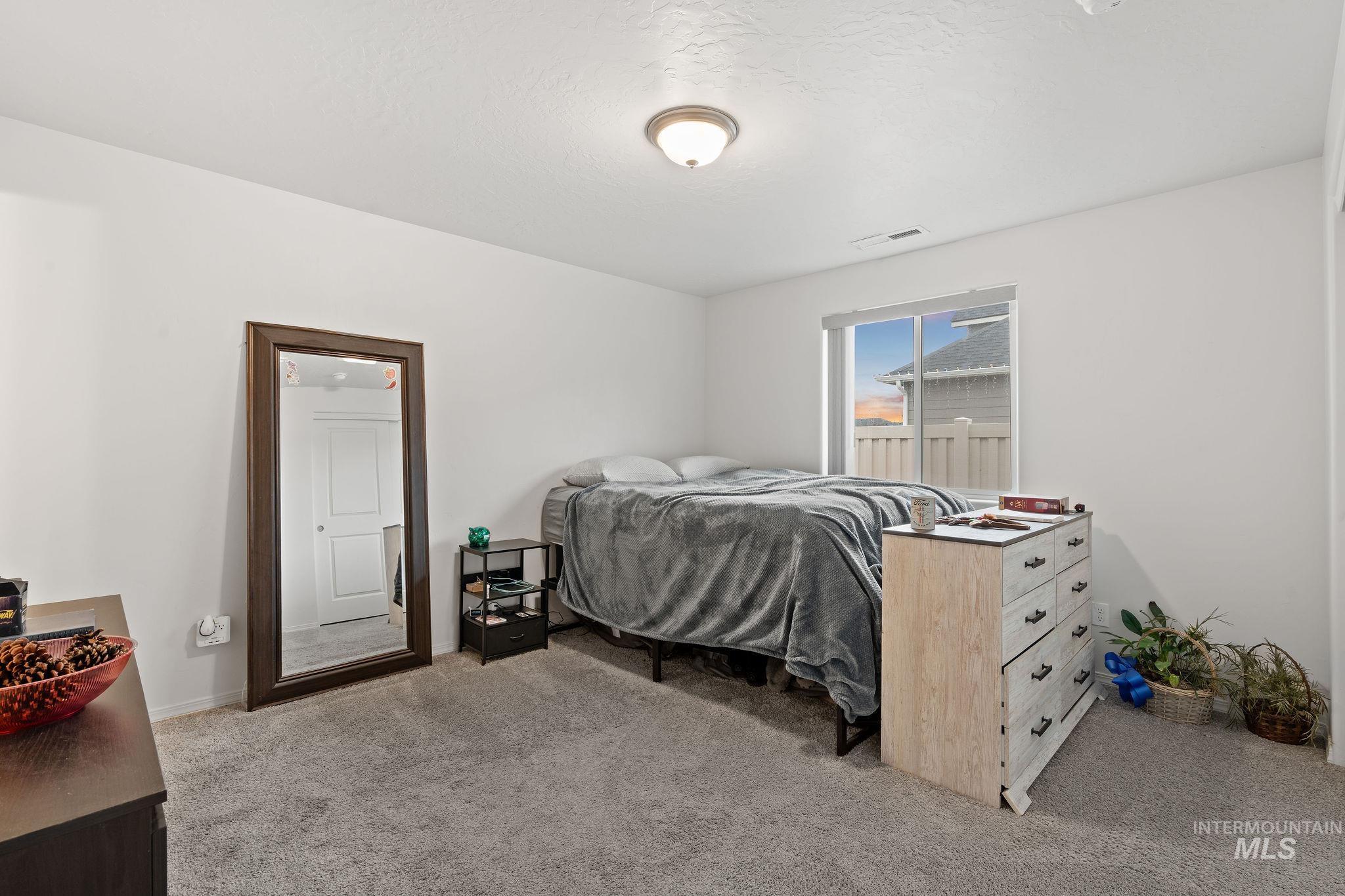 Bedroom with light carpet