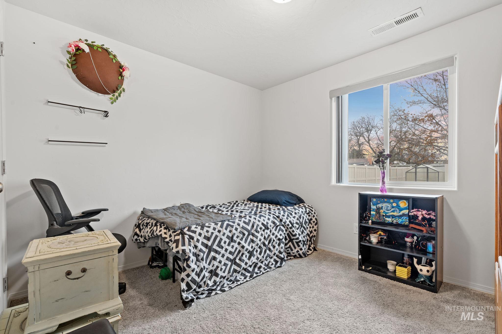 Carpeted bedroom featuring baseboards