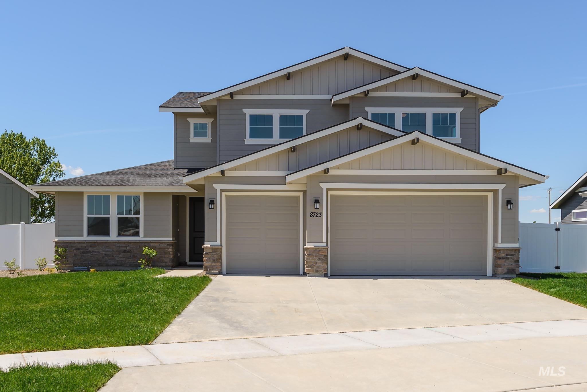 Craftsman-style house featuring concrete driveway, a shingled roof, stone siding, and an attached garage
