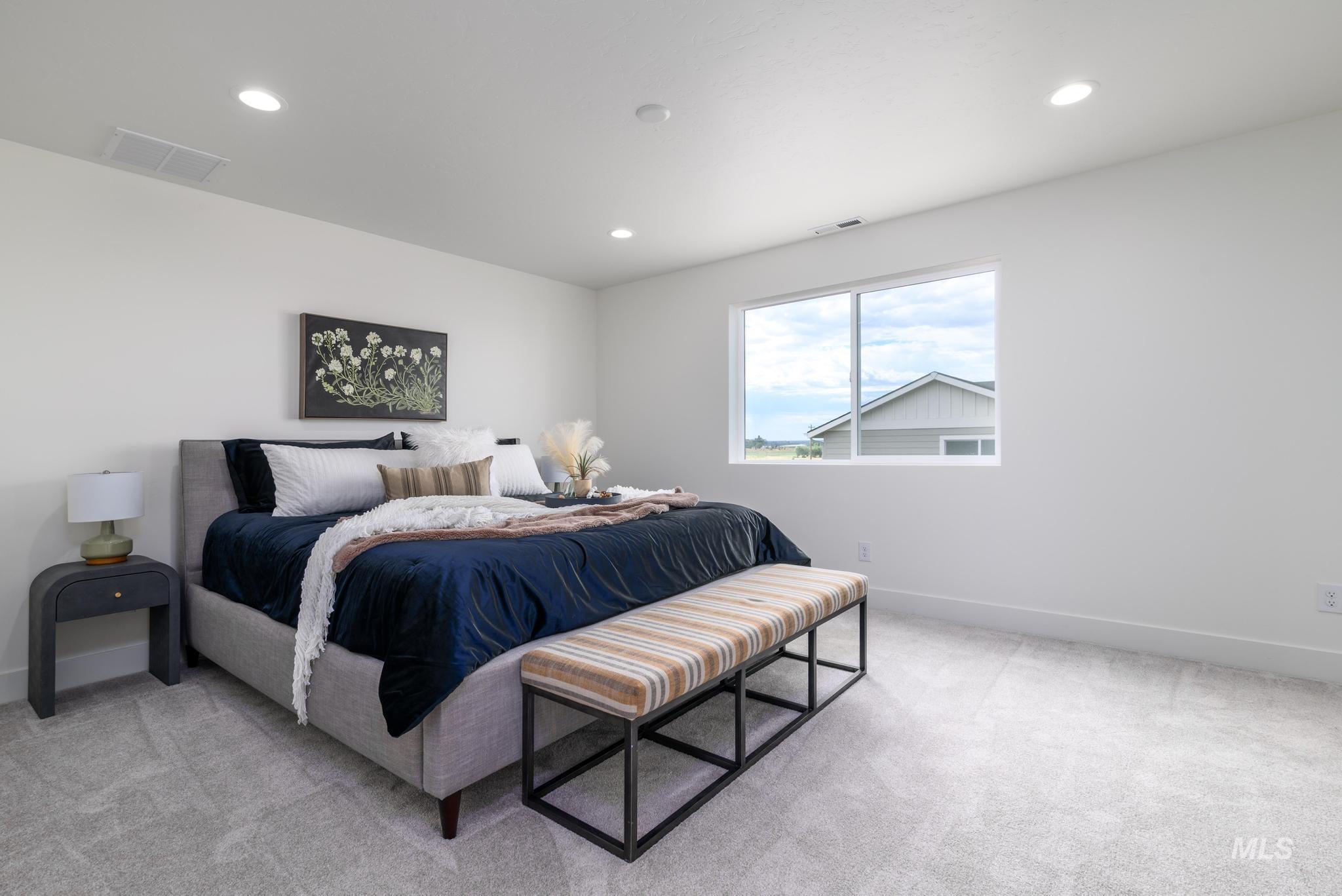 Bedroom featuring light carpet and recessed lighting