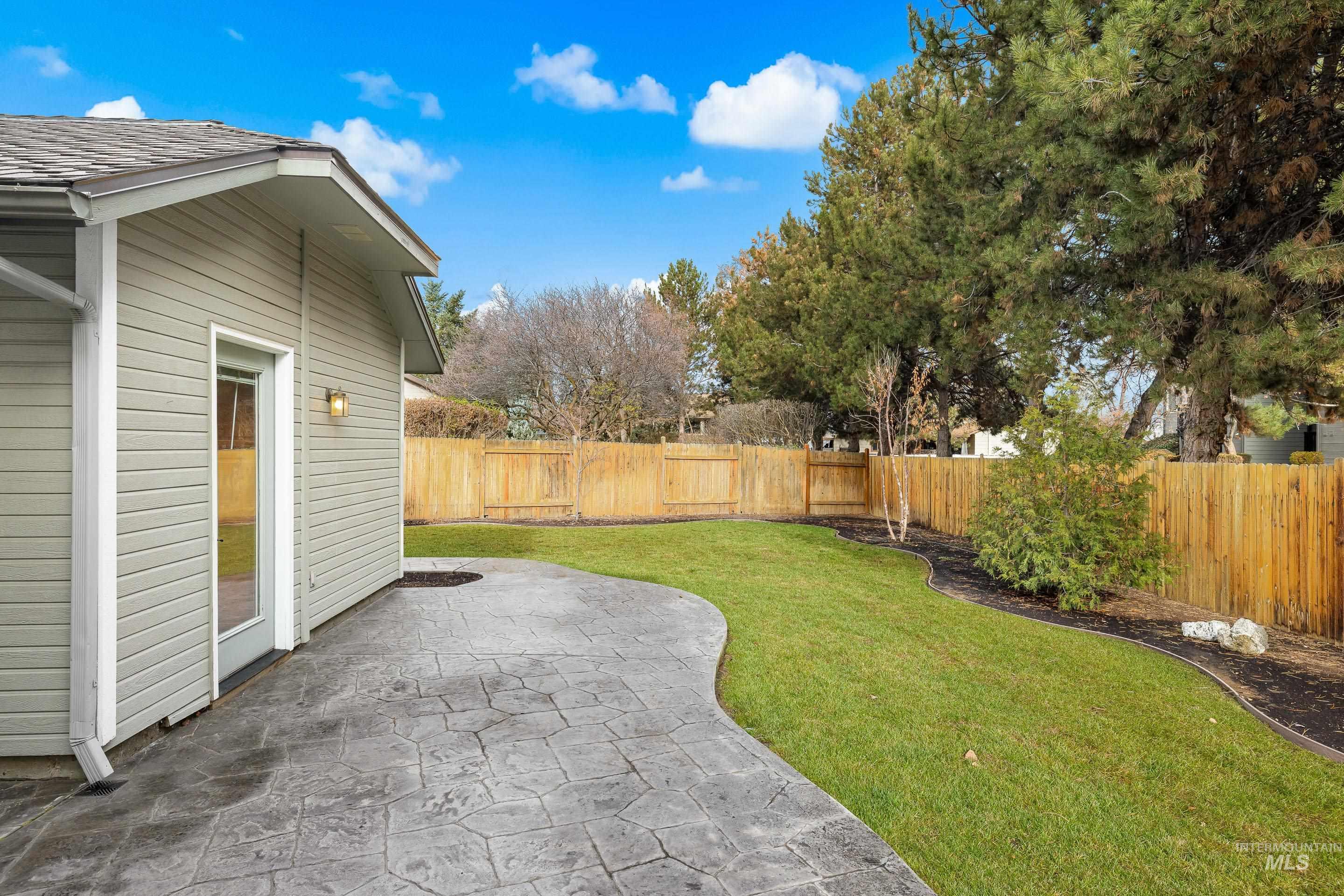 Fenced backyard with a patio