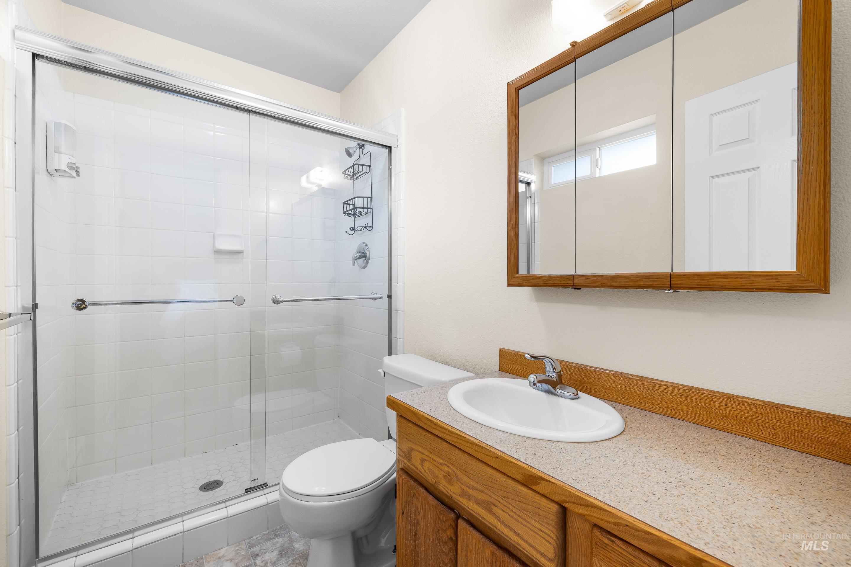 Full bathroom with a shower stall and vanity
