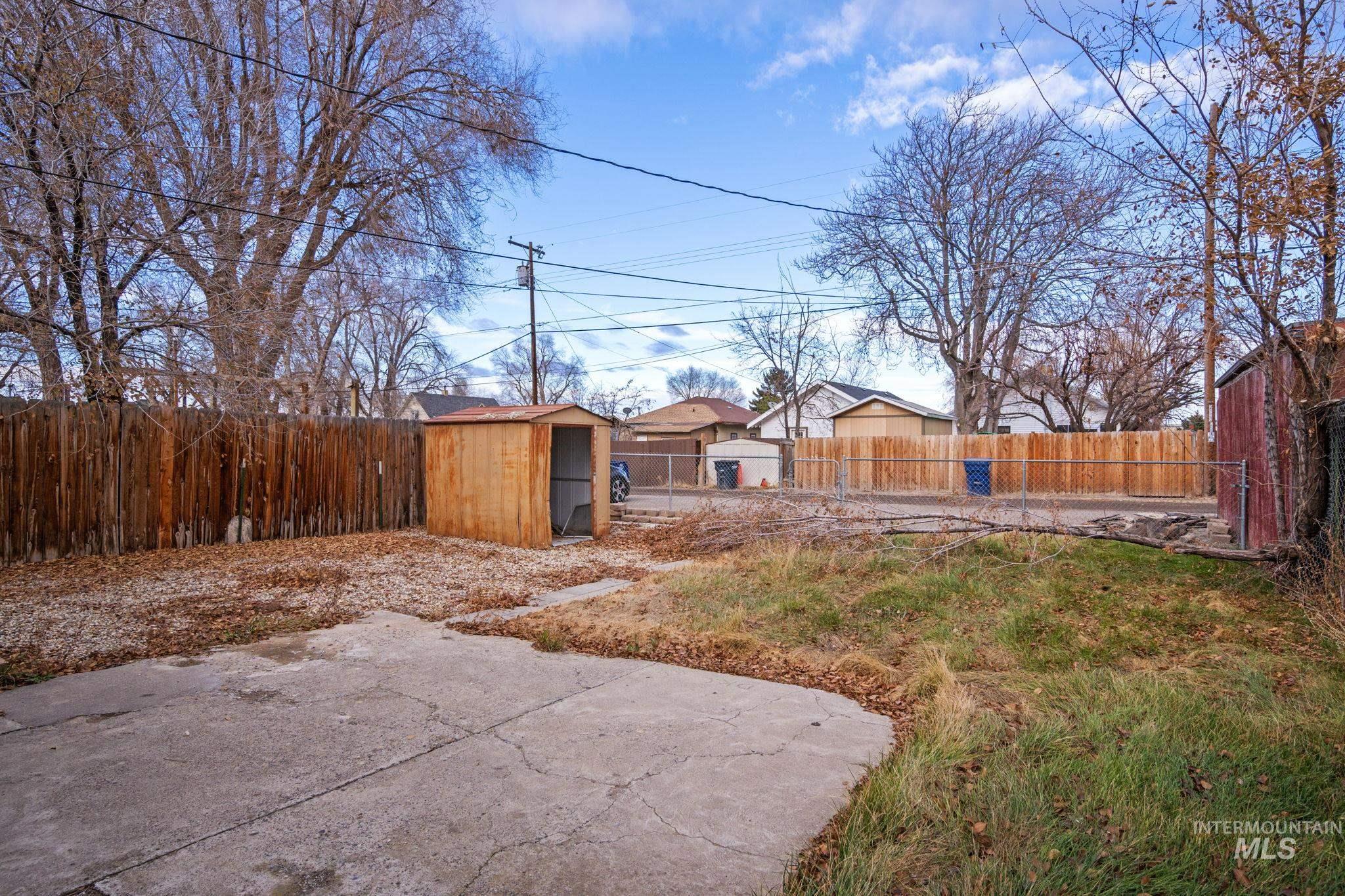 Fenced backyard with a storage shed