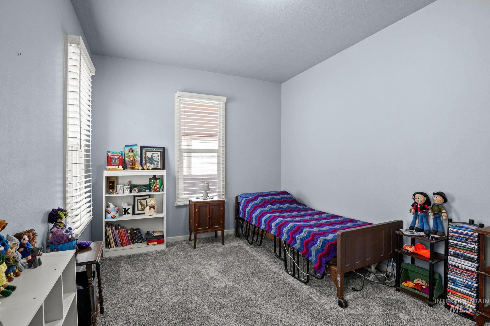 Carpeted bedroom featuring baseboards