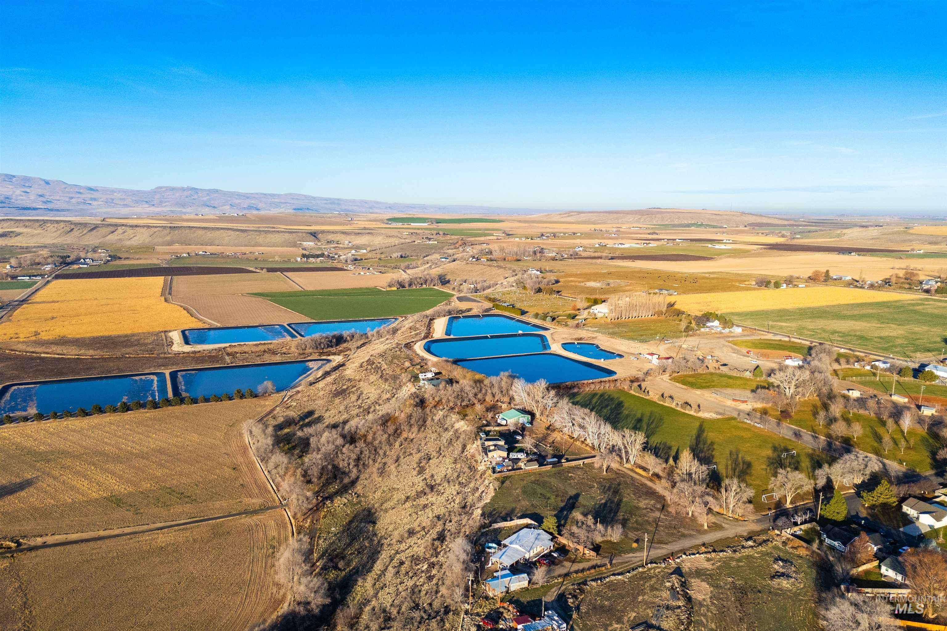 Aerial overview of property's location with rural landscape and a water and mountain view