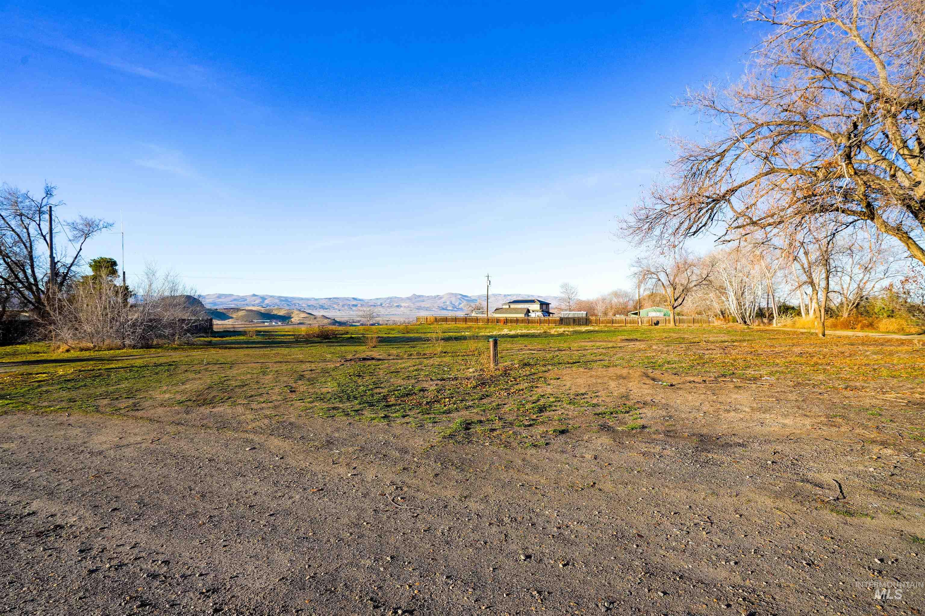 View of yard with a rural view and a mountain view