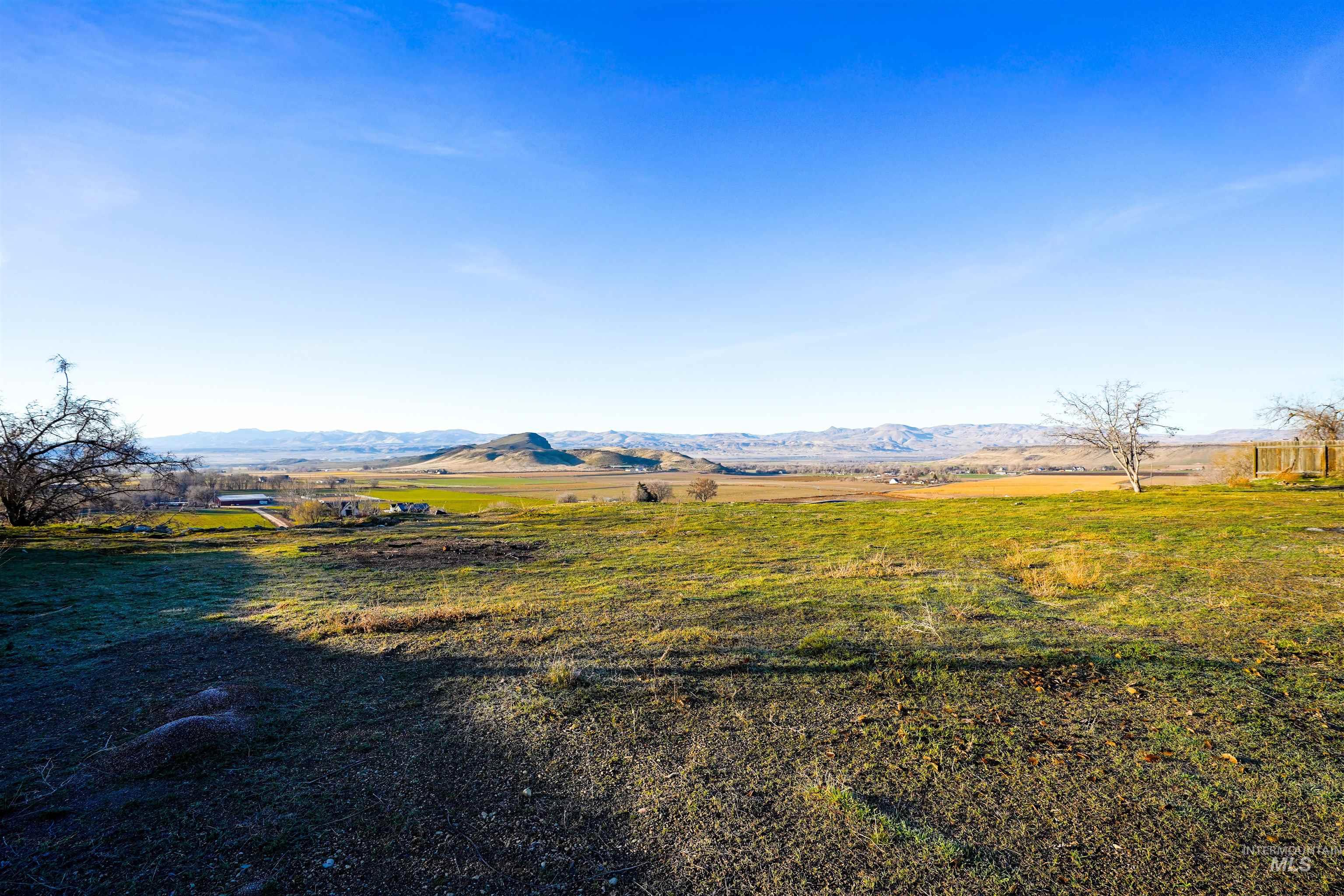 View of grassy yard featuring a view of countryside and a mountain view