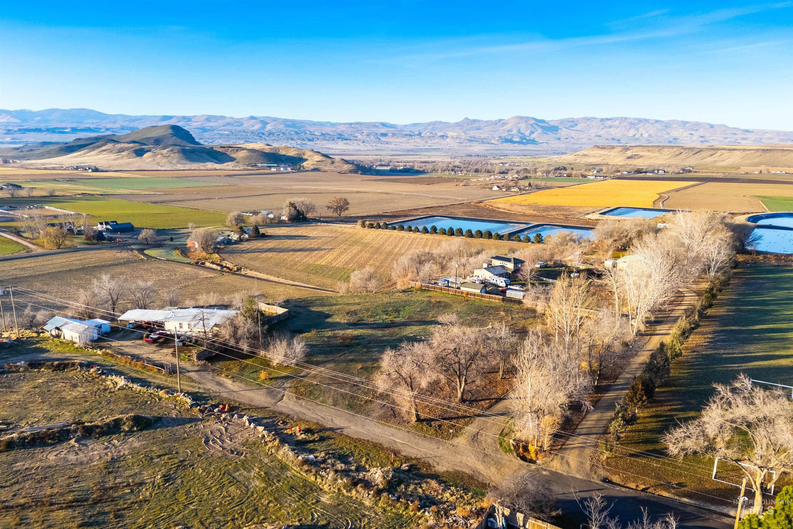 View of rural area with mountains and rows of crops