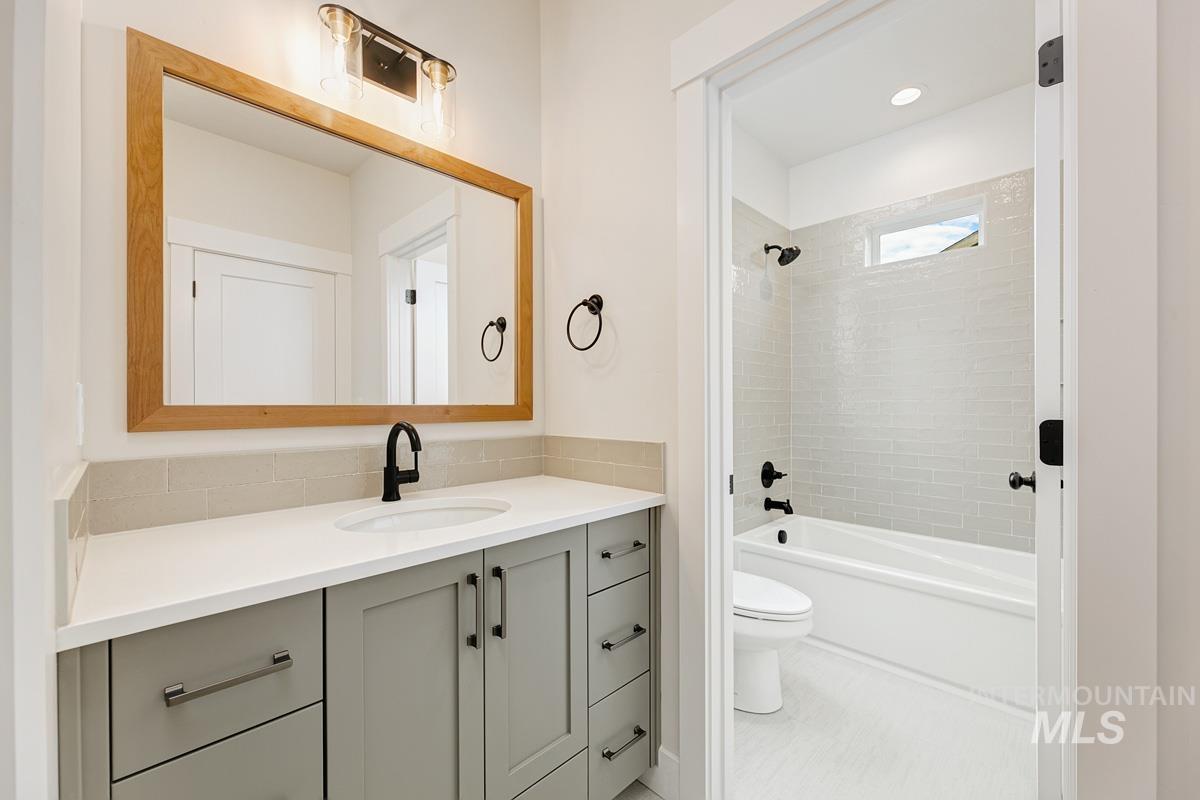 Full bathroom featuring vanity, tub / shower combination, and tile patterned flooring