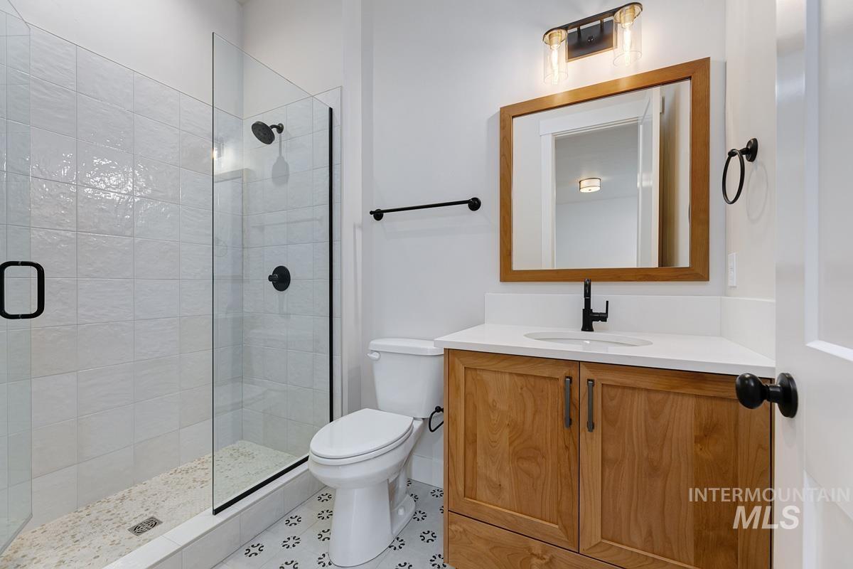 Full bathroom with vanity and a stall shower
