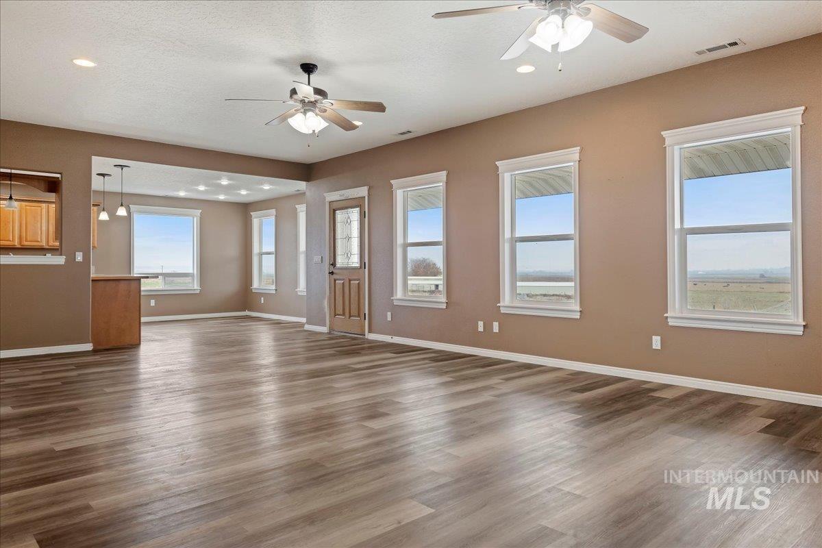 Entrance foyer featuring dark wood-type flooring, ceiling fan, a textured ceiling, and recessed lighting