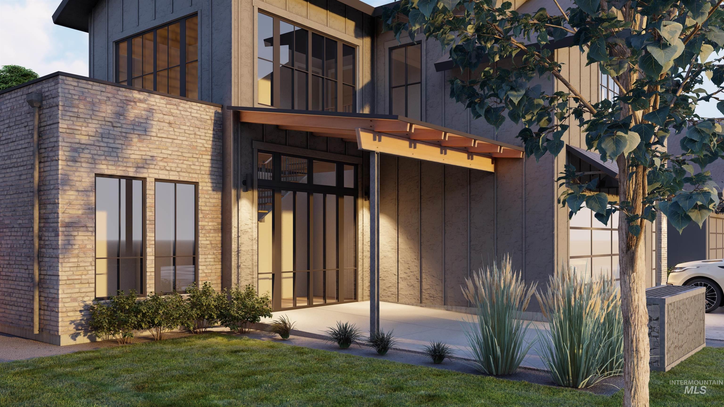 Double front door with lots of surrounding windows & brick