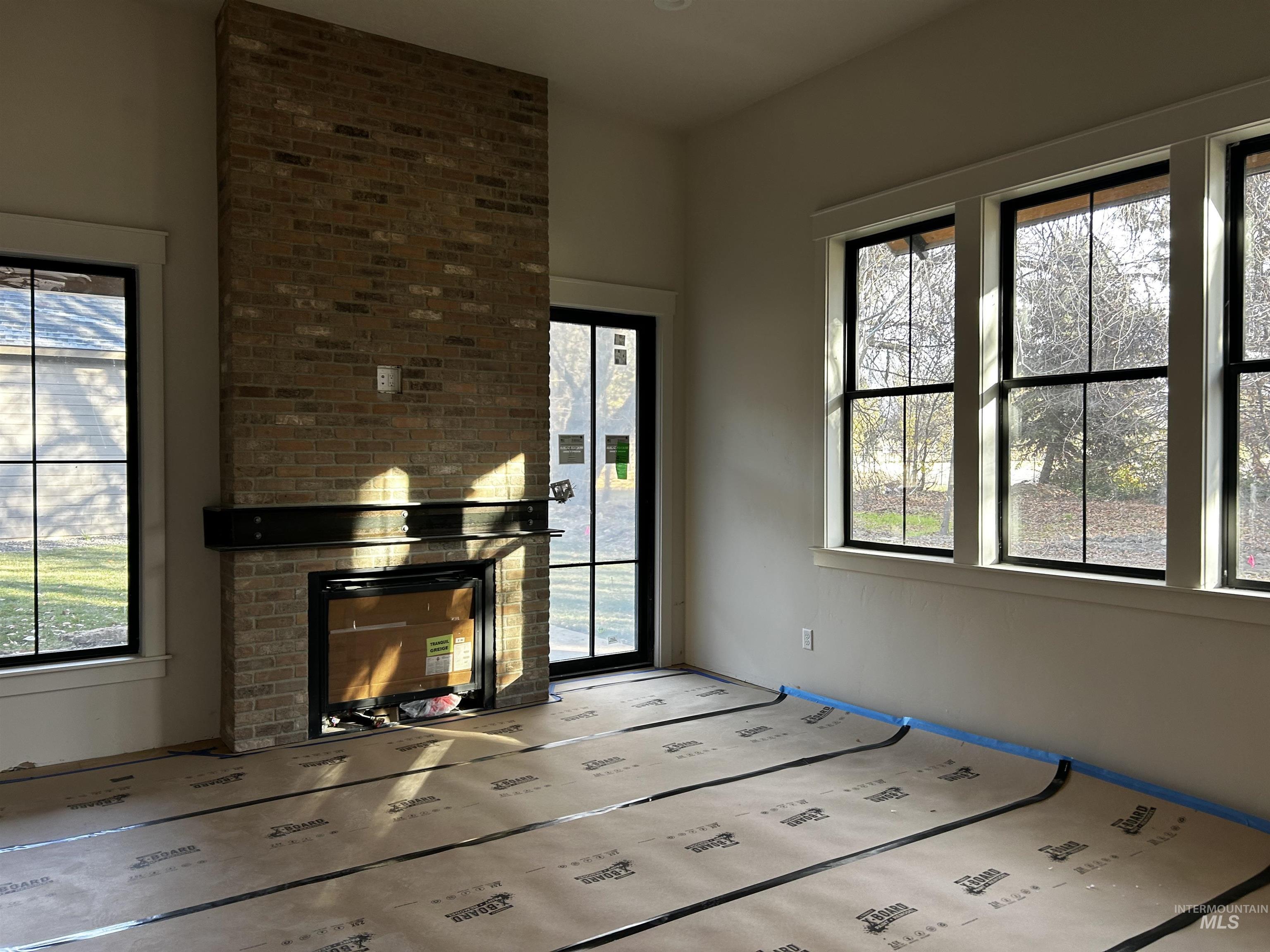 Fireplace, hardwood flooring, door to covered patio and private backyard.