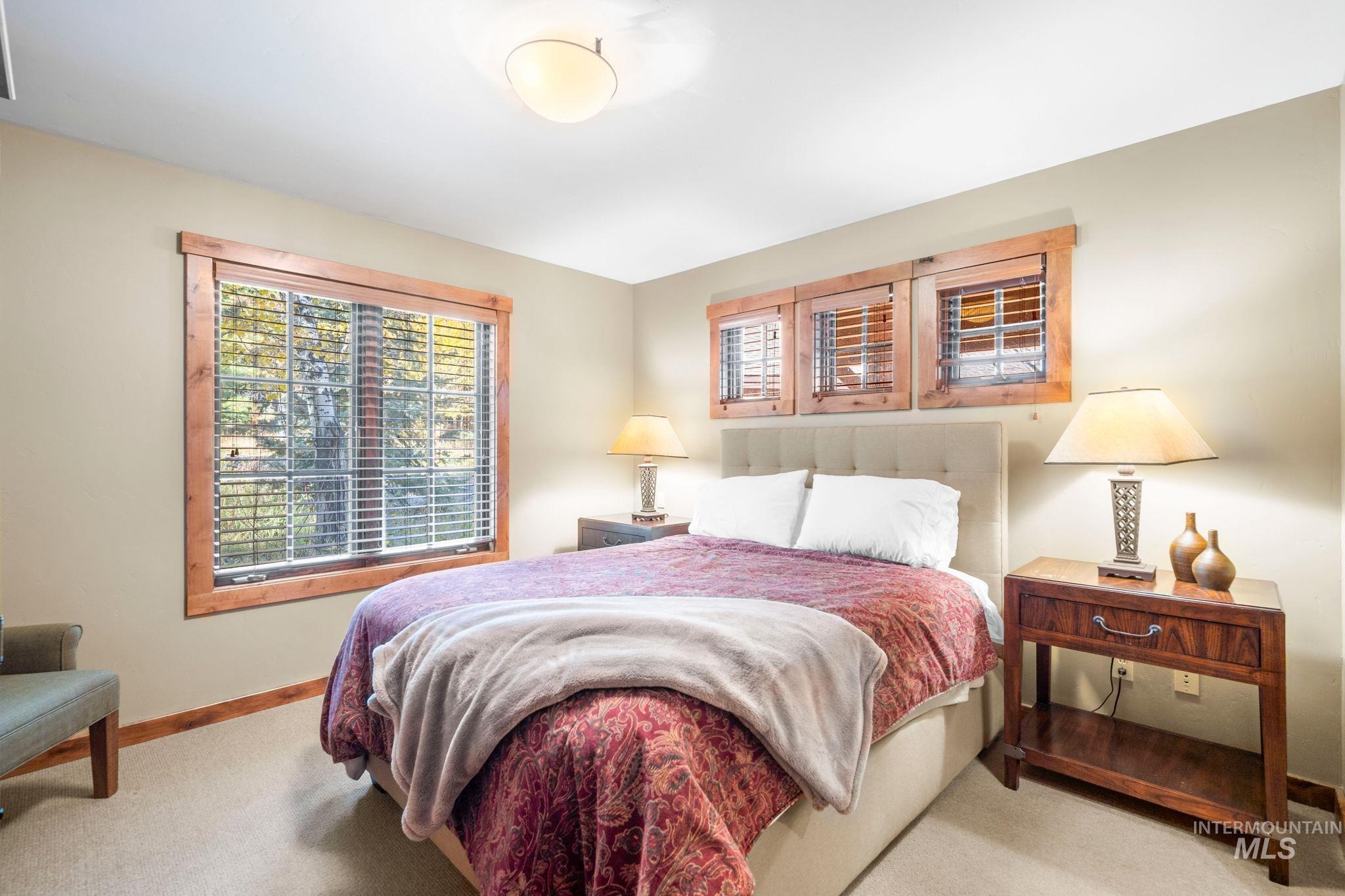 Carpeted bedroom featuring baseboards