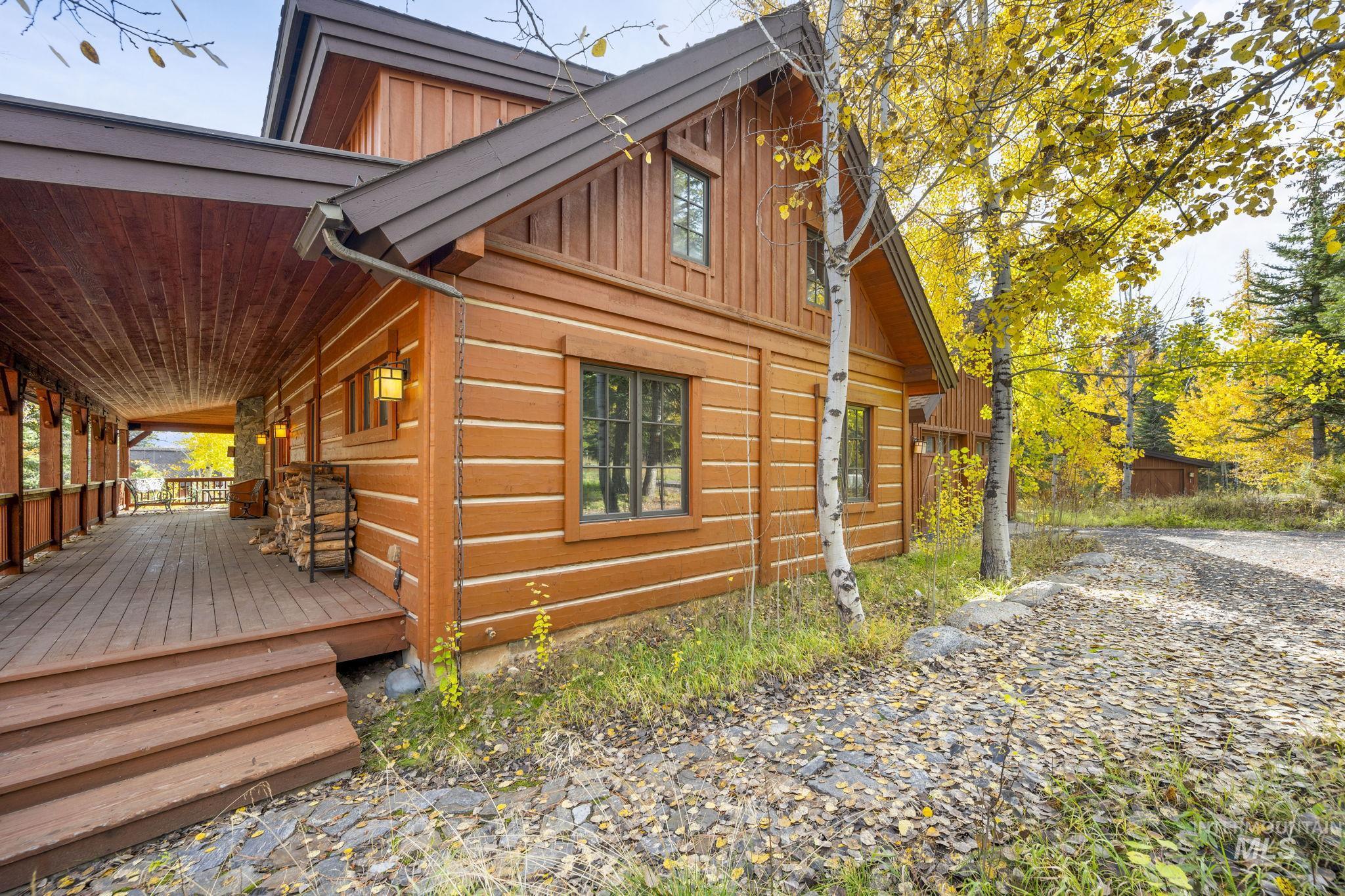 View of side of home featuring board and batten siding and a wooden deck