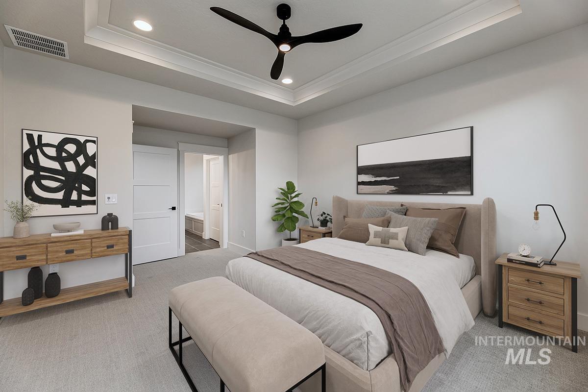 Bedroom featuring light carpet, crown molding, a ceiling fan, recessed lighting, and a tray ceiling