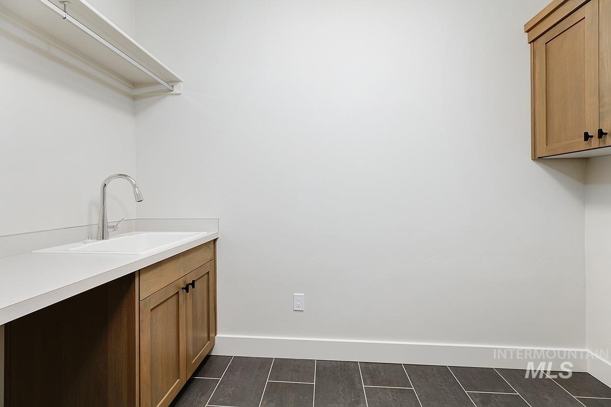 Washroom with baseboards and wood tiled floors
