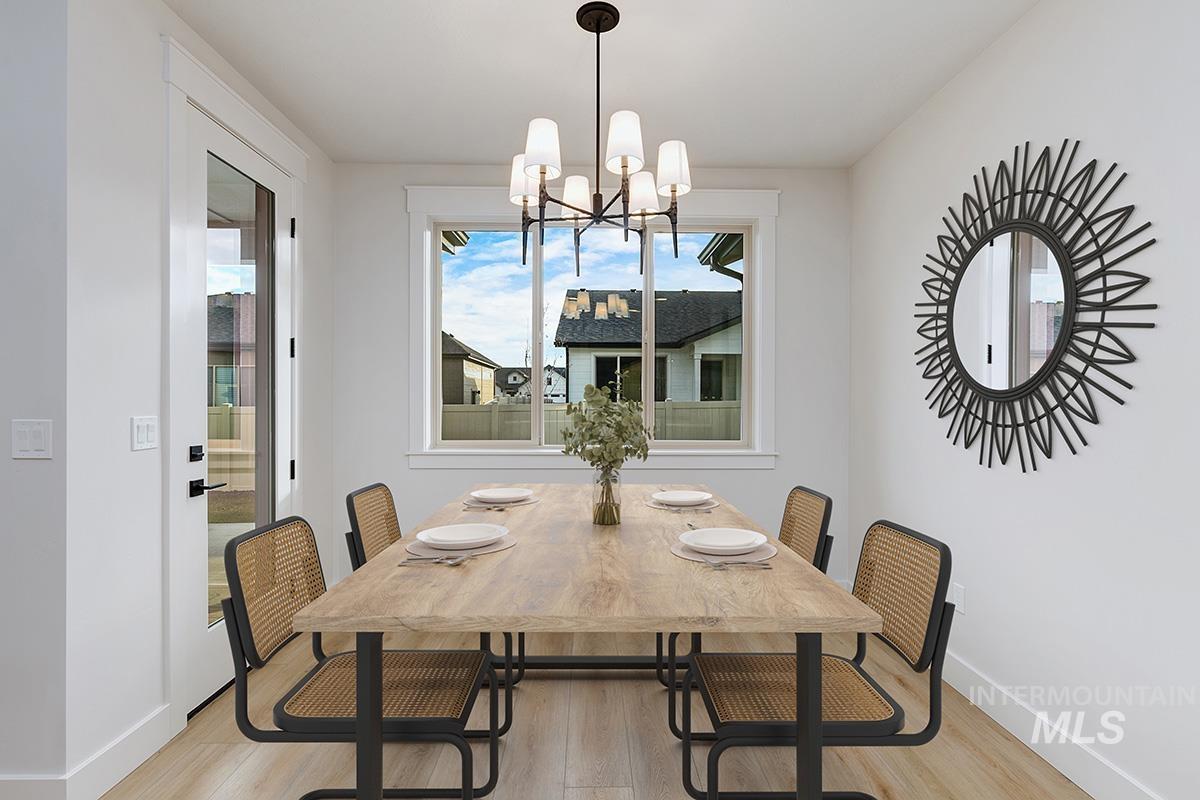 Dining space featuring light wood-style floors and a chandelier