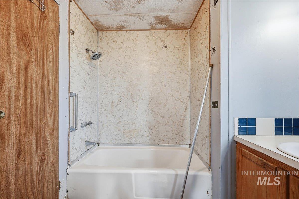 Bathroom featuring vanity and bathtub / shower combination