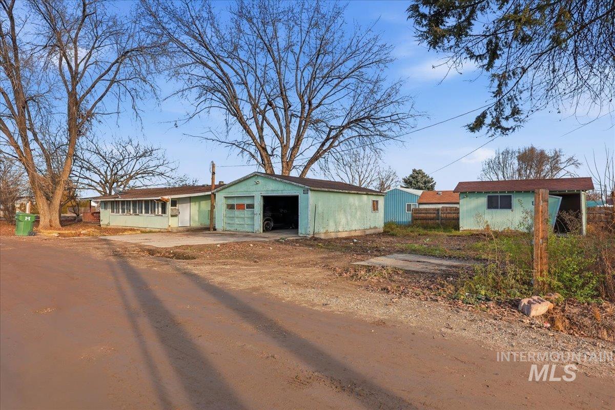 View of outbuilding featuring dirt driveway