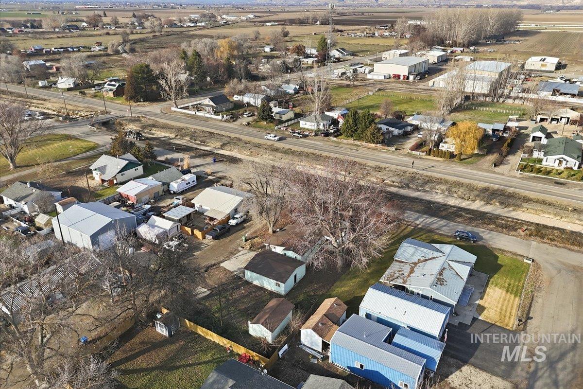 Aerial view of property and surrounding area with nearby suburban area