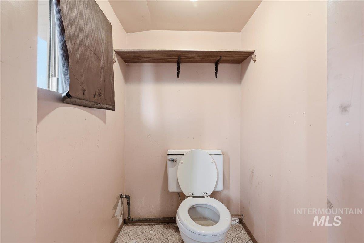 Bathroom featuring toilet and light floors