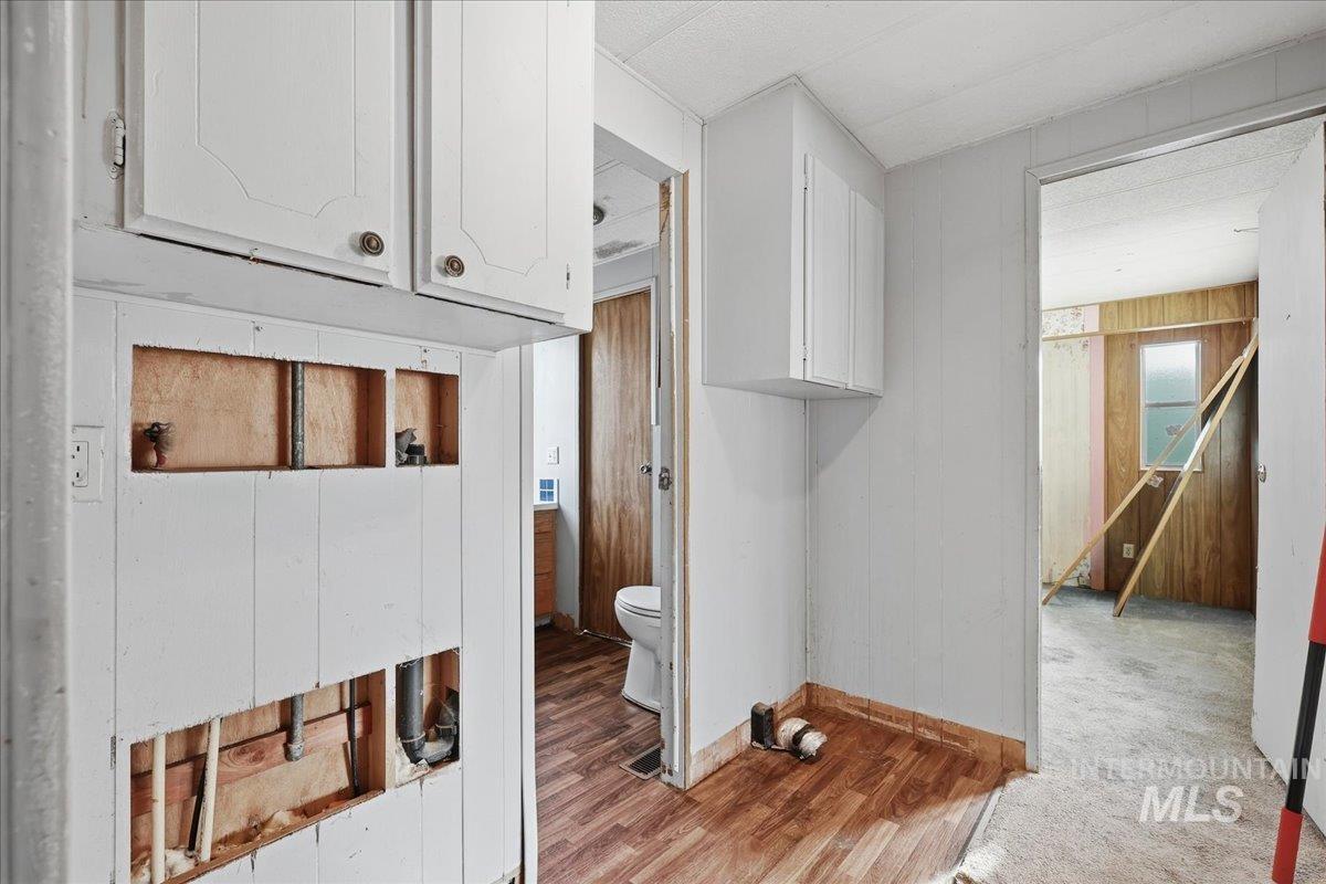 Corridor with wood walls and light wood-style floors