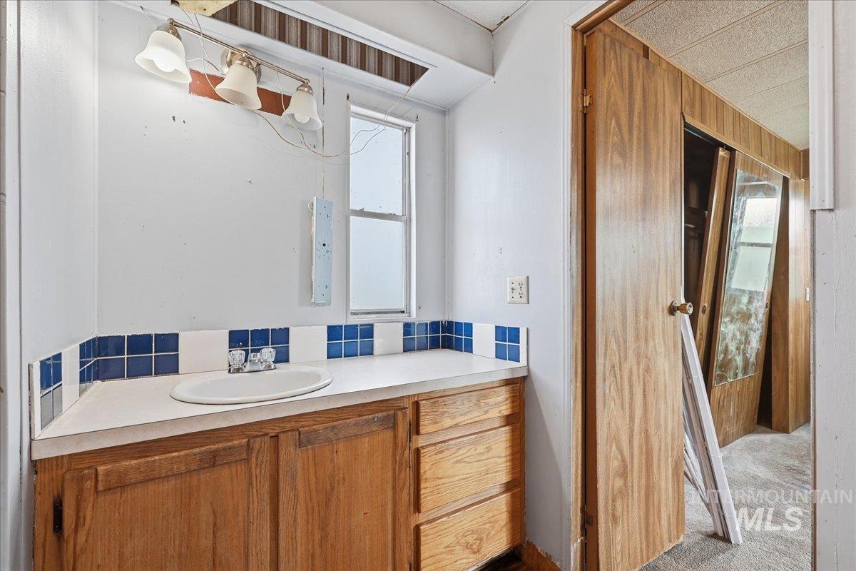 Bathroom with vanity and carpet floors