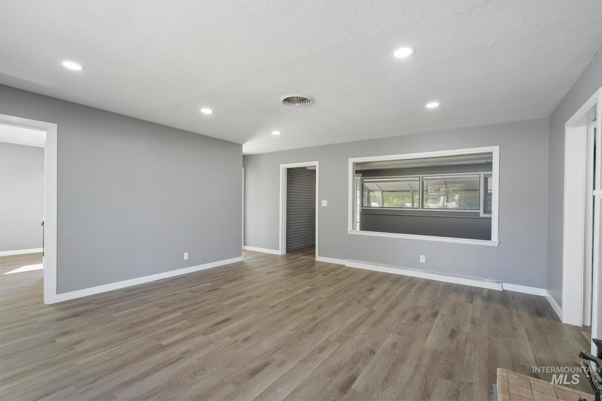 Unfurnished living room with light wood-style flooring and recessed lighting