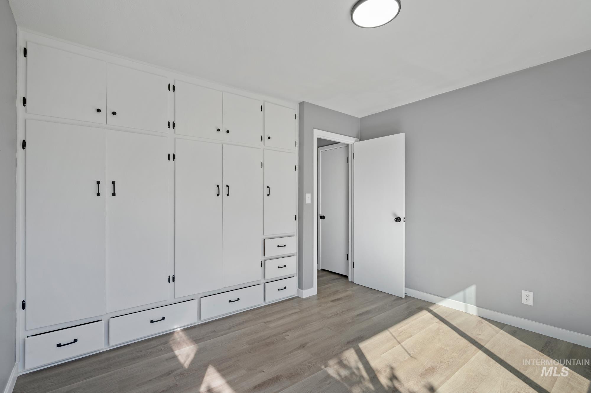 Unfurnished bedroom featuring a closet and light wood-style floors