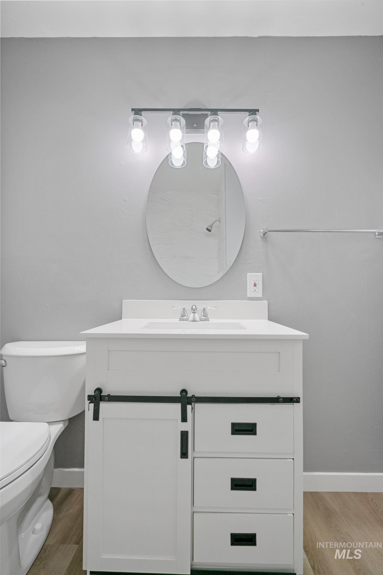 Half bath with vanity and light wood-style flooring