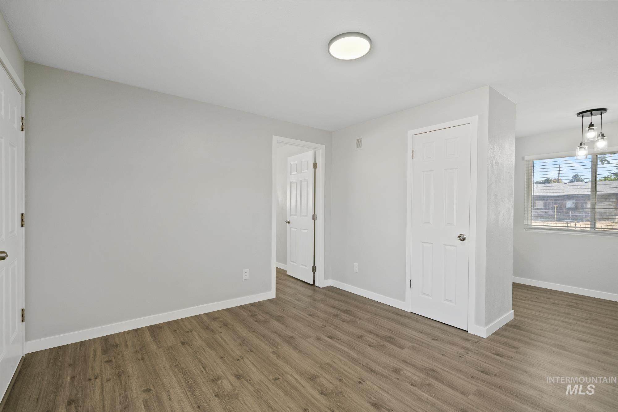 Unfurnished bedroom featuring wood finished floors and a closet