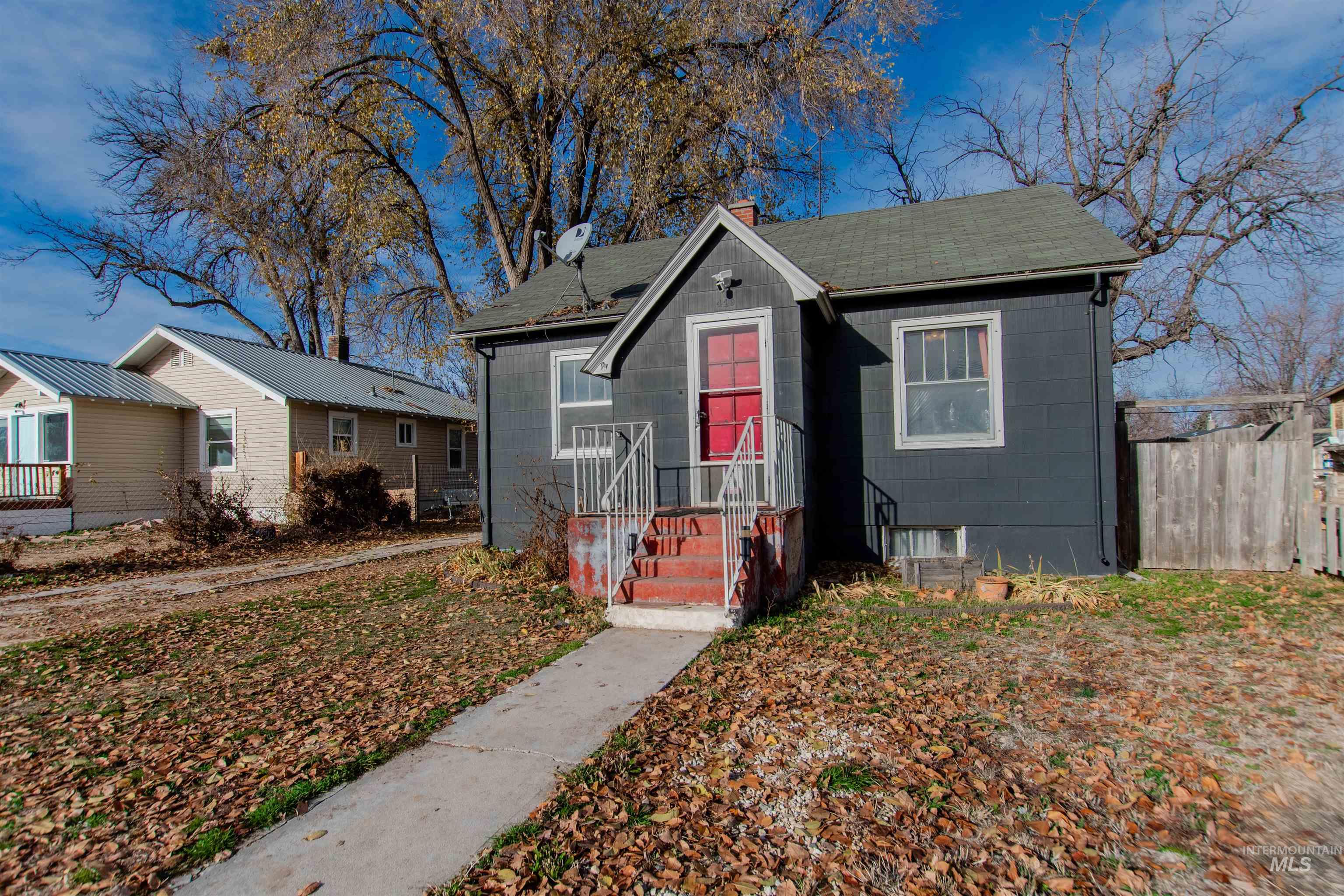 Bungalow-style home with a chimney and a shingled roof