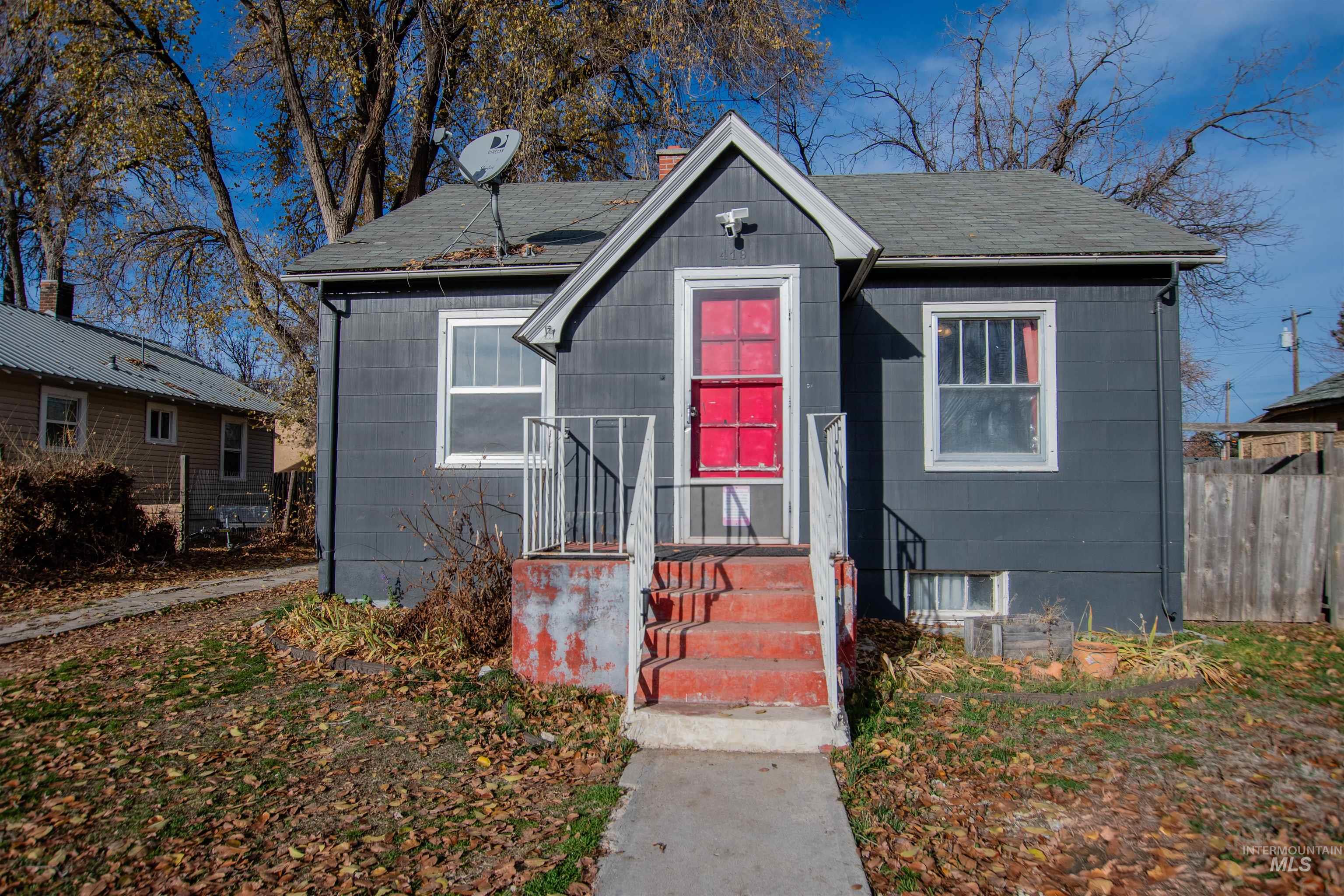 Bungalow with a shingled roof and a chimney