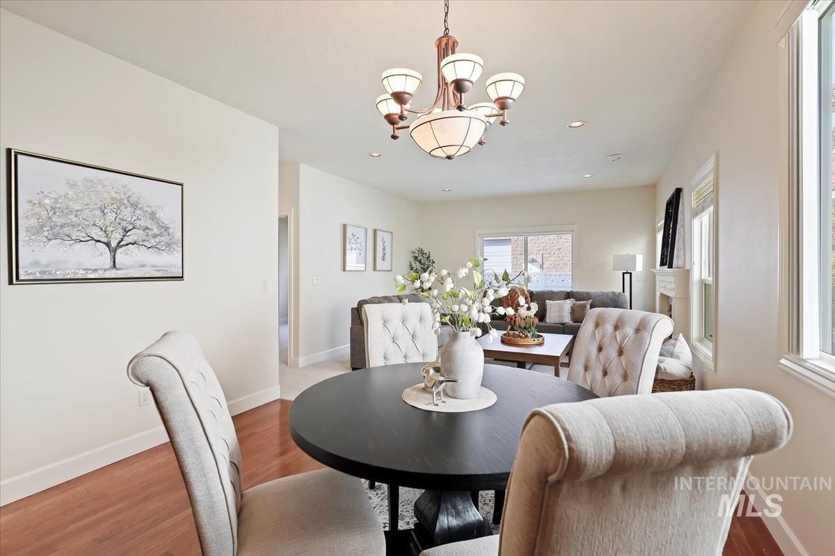 Dining area featuring wood finished floors, a chandelier, and recessed lighting