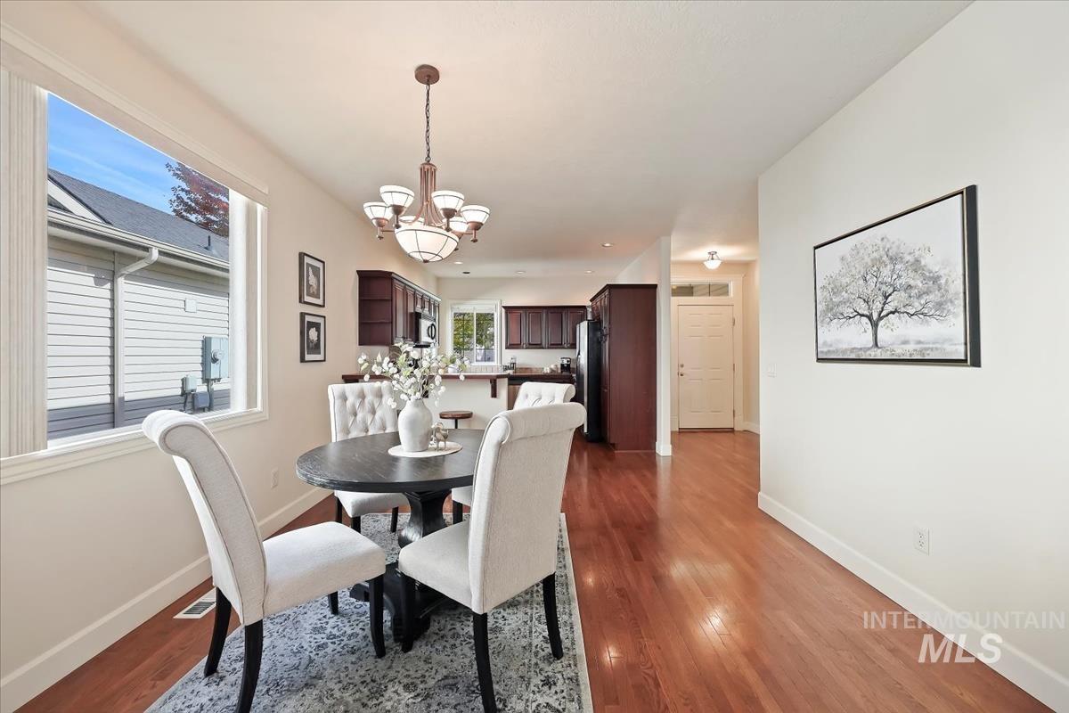 Dining room featuring a chandelier and dark wood-type flooring