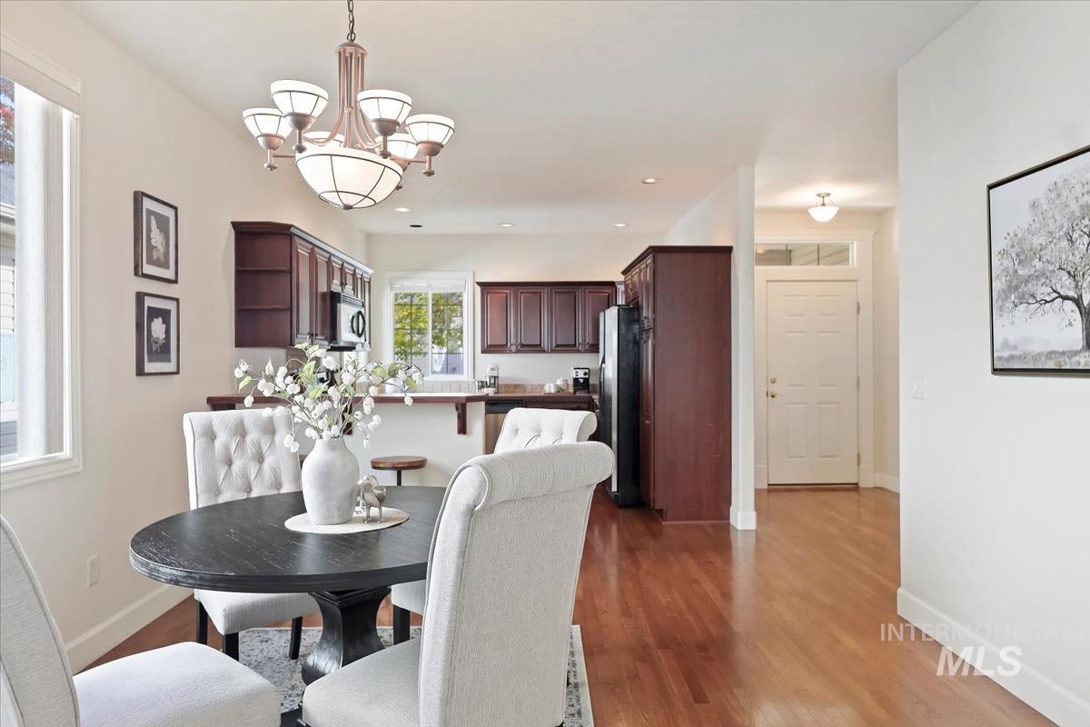 Dining area featuring light wood-style floors and a chandelier