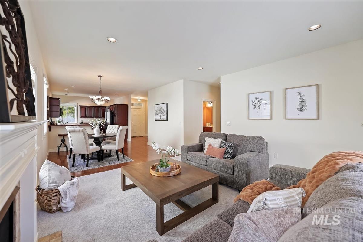 Living area featuring recessed lighting, light wood-type flooring, and a chandelier