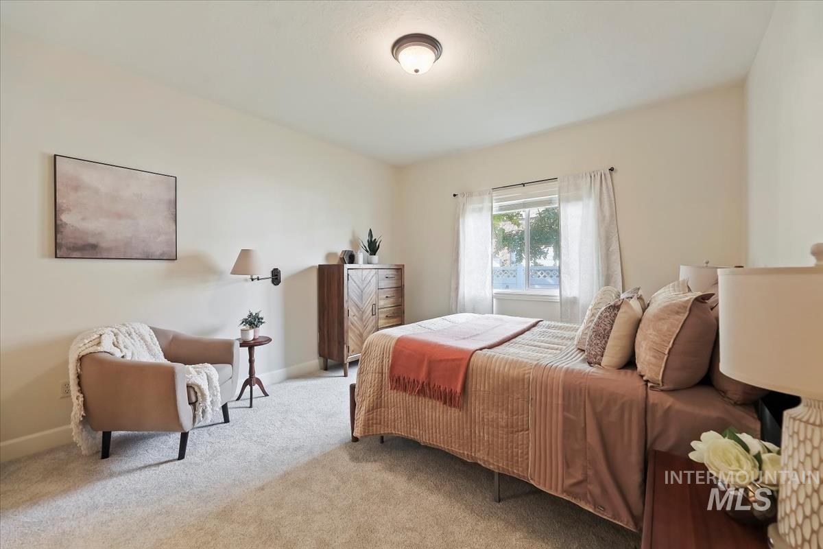 Bedroom featuring carpet flooring and baseboards
