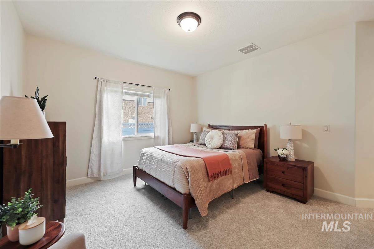 Bedroom featuring light colored carpet