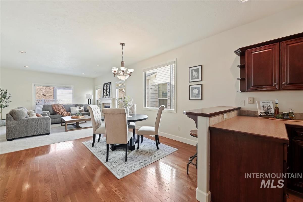 Dining space with recessed lighting, light wood-style flooring, and a chandelier