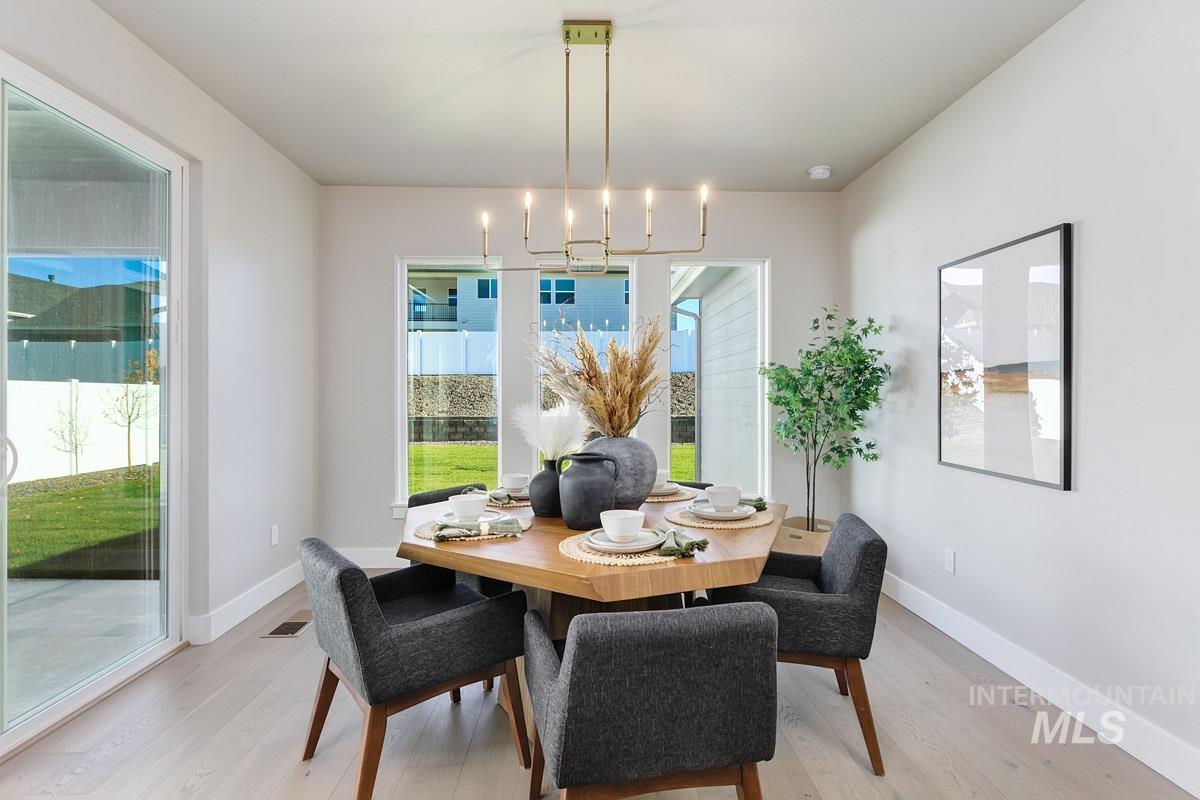 Dining room with light wood finished floors and baseboards