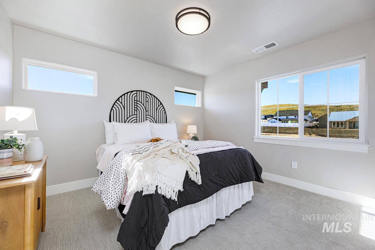 Carpeted bedroom featuring baseboards