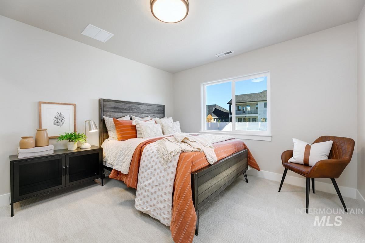 Bedroom with light carpet and baseboards