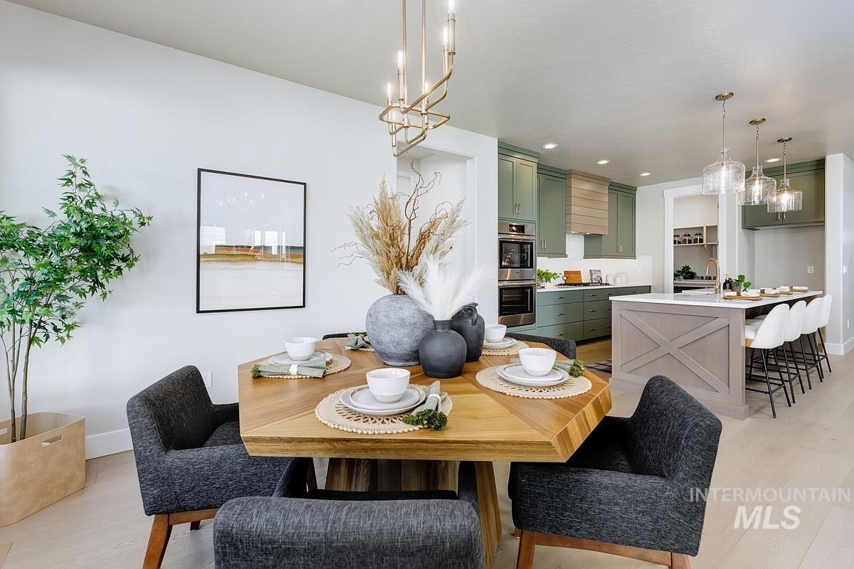 Dining room with light wood-type flooring and recessed lighting