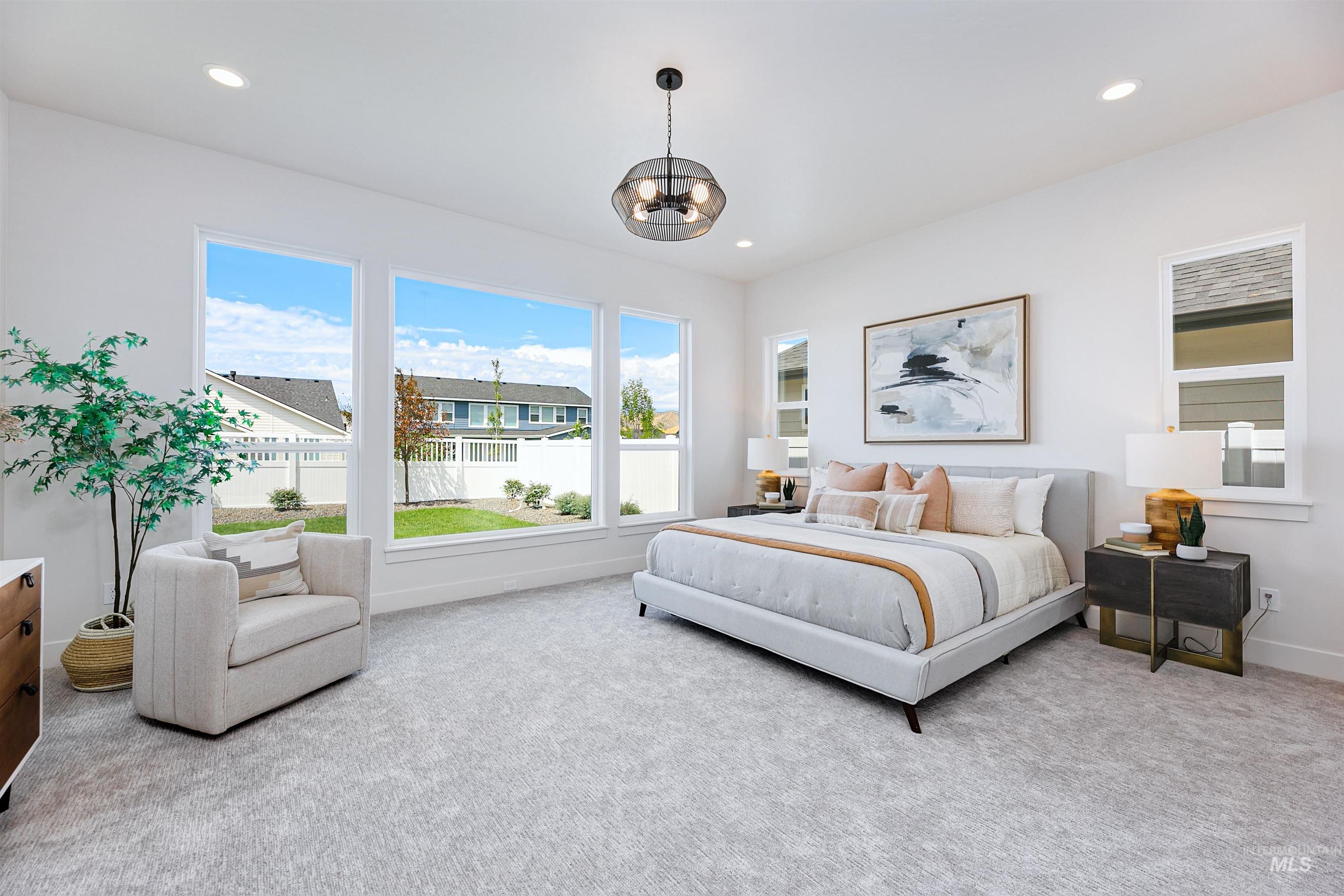 Carpeted bedroom featuring a chandelier and recessed lighting
