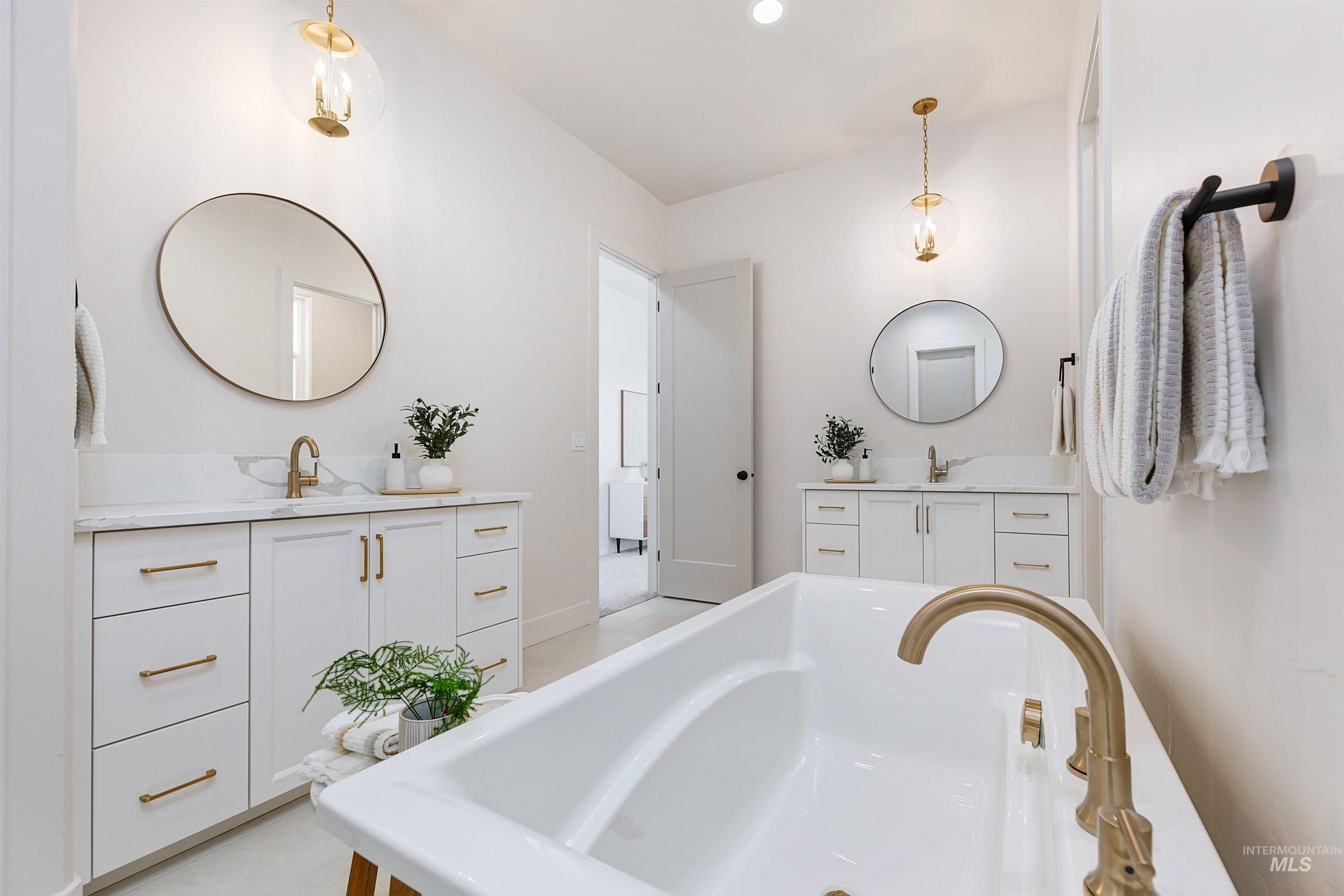 Bathroom with a freestanding tub and two vanities
