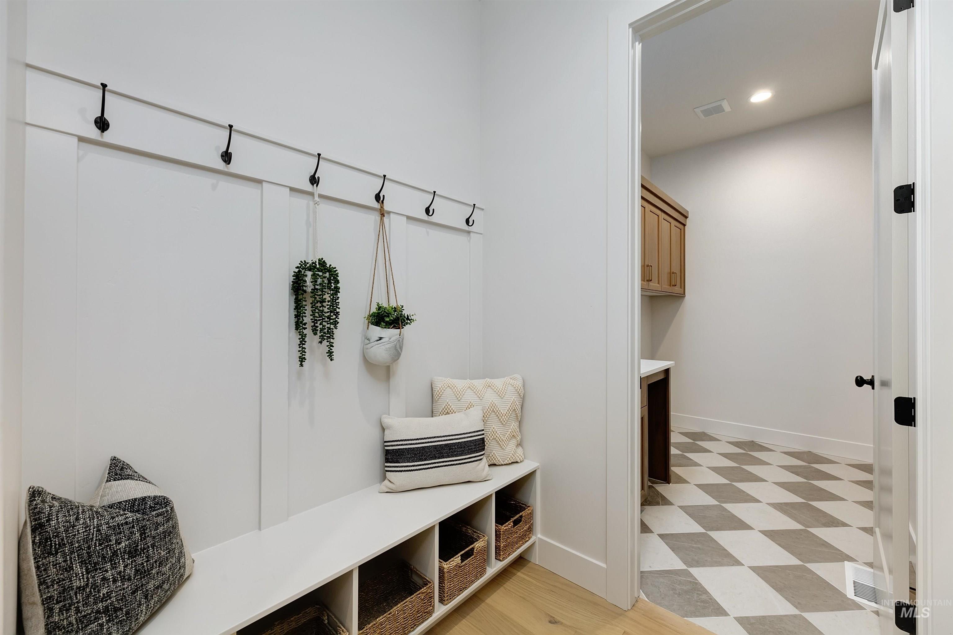 Mudroom with light flooring and recessed lighting