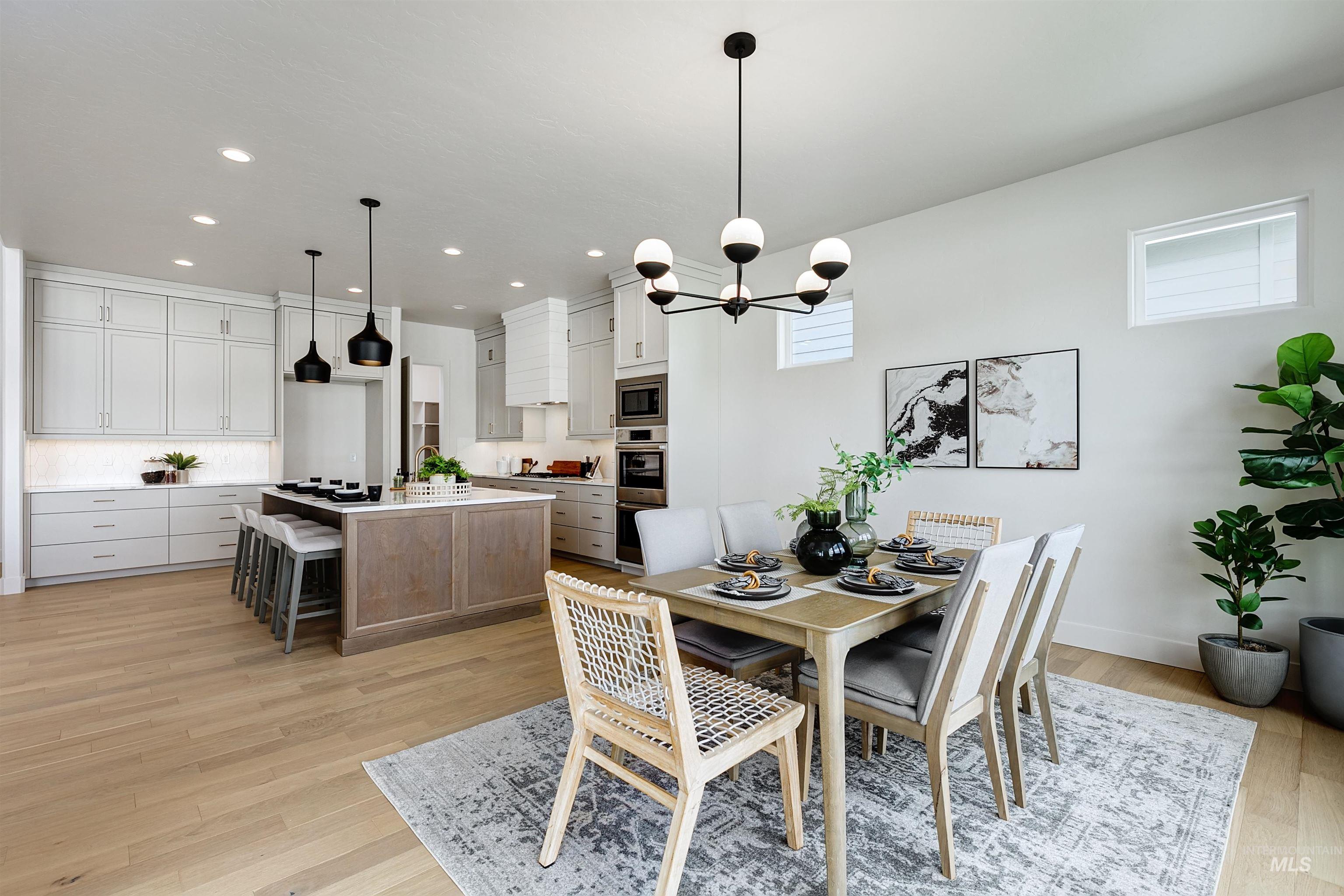 Dining room featuring light wood-style floors, recessed lighting, and a chandelier